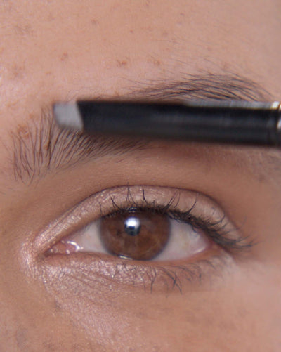 Applying Brow Definer in Ebony and Brow Freeze® Gel