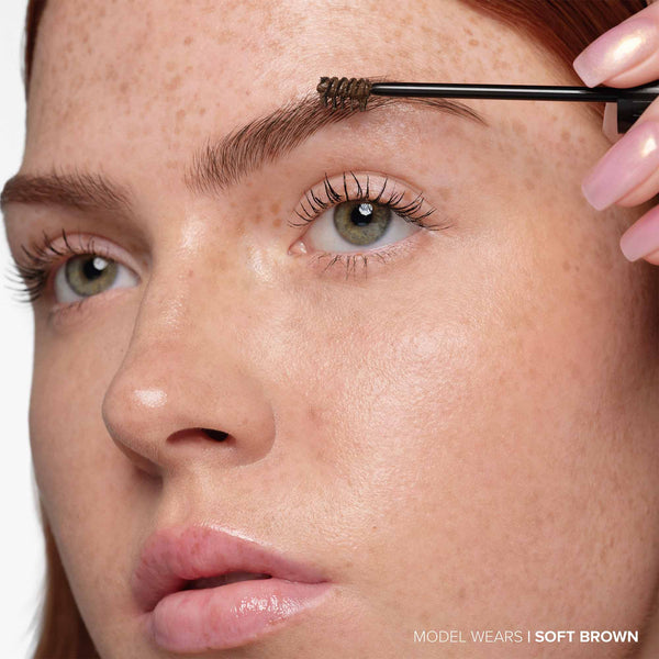  Soft Brown | Volumizing Tinted Brow Gel -Model Holding Product Wand